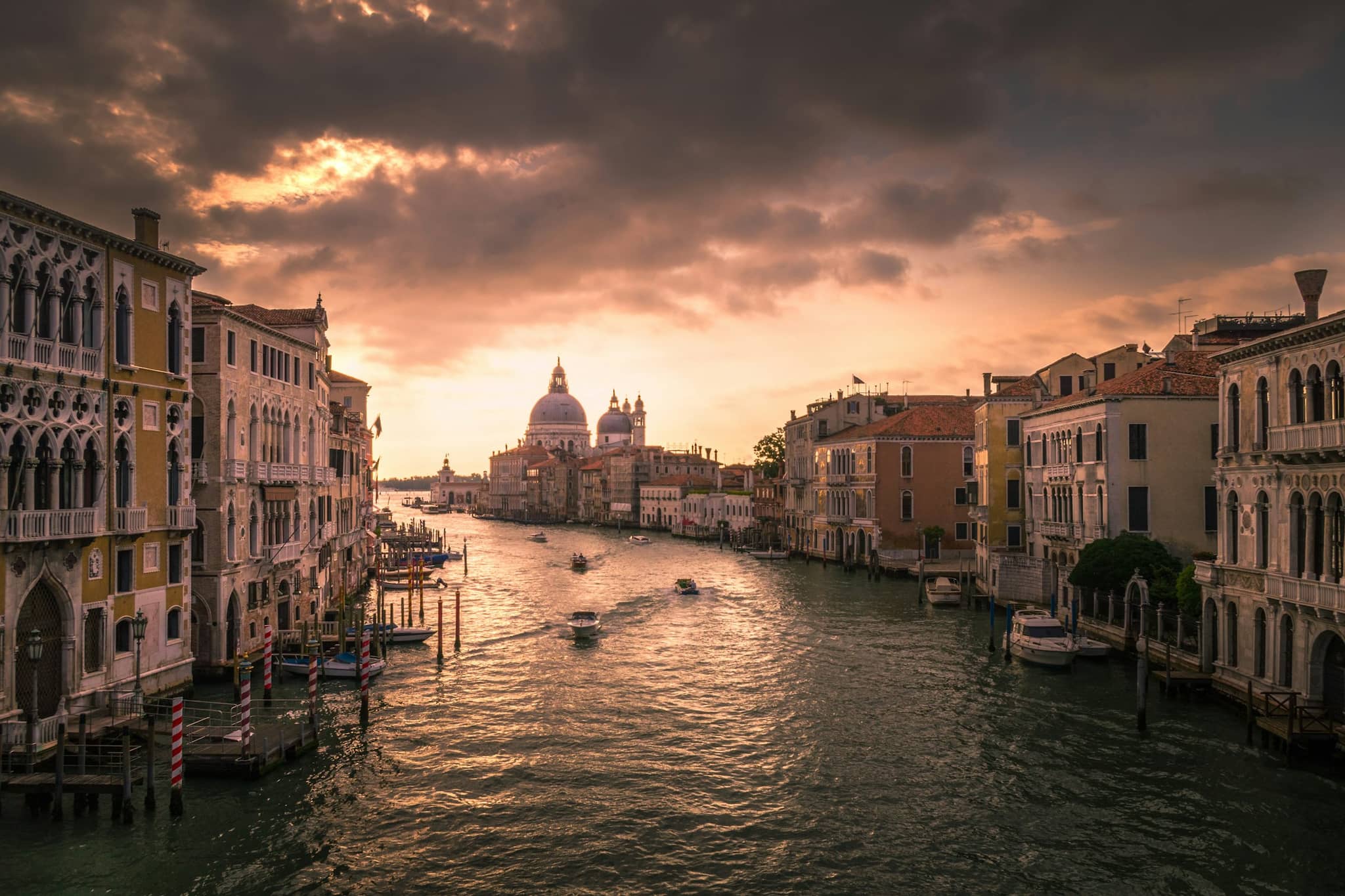 Quiet Castello waterside at evening, residential facades on the opposite bank of a wide canal.