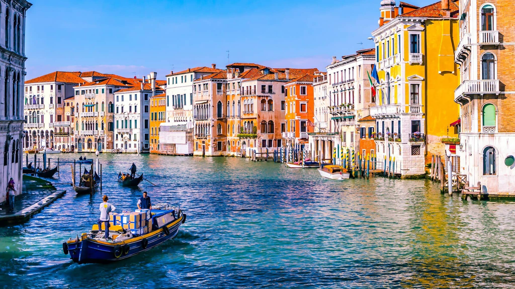 A fondamenta runs alongside a quiet canal in central Venice, period building facades on the opposite bank.